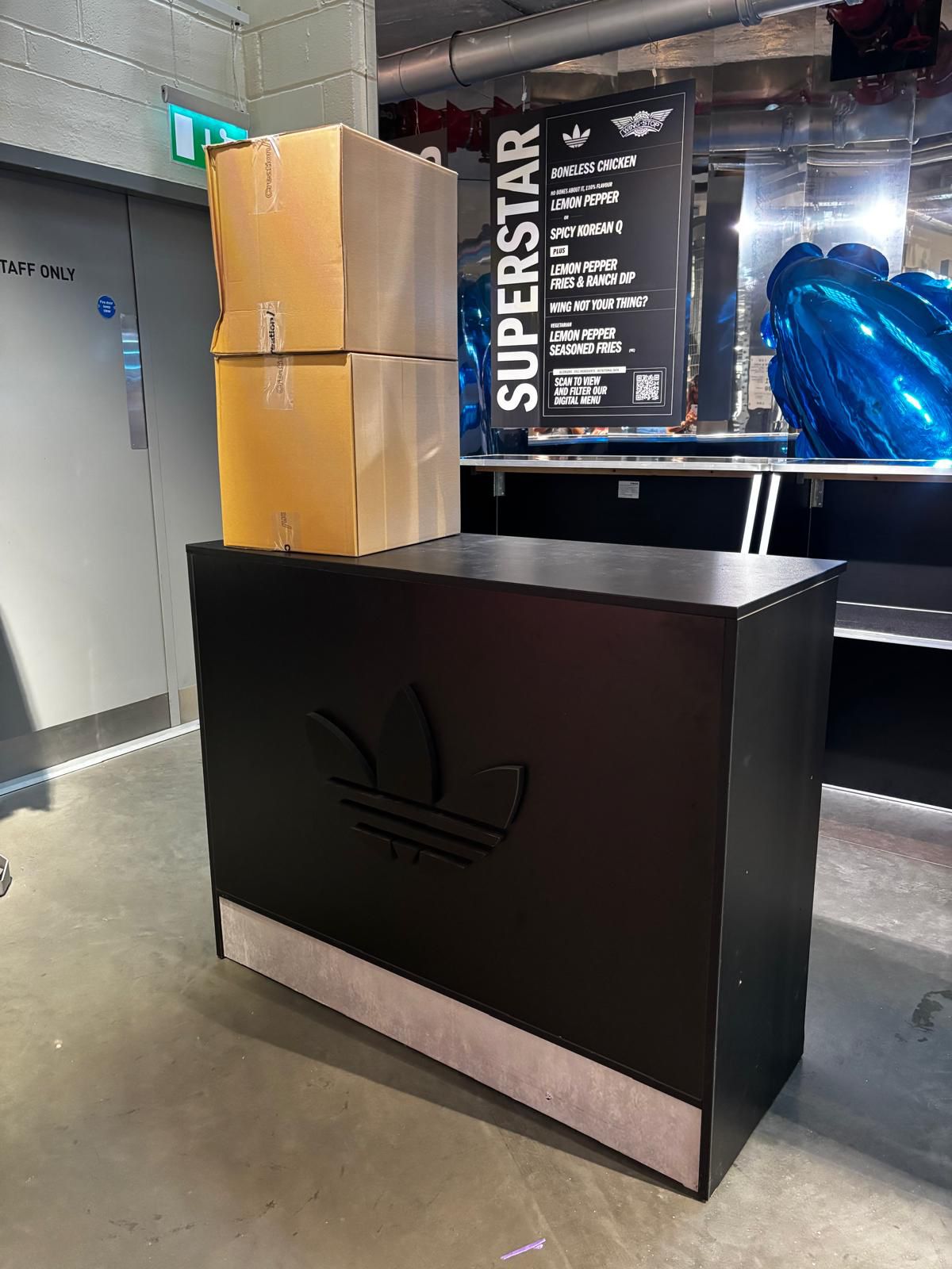 Branded black bar counter unit at an indoor brand activation