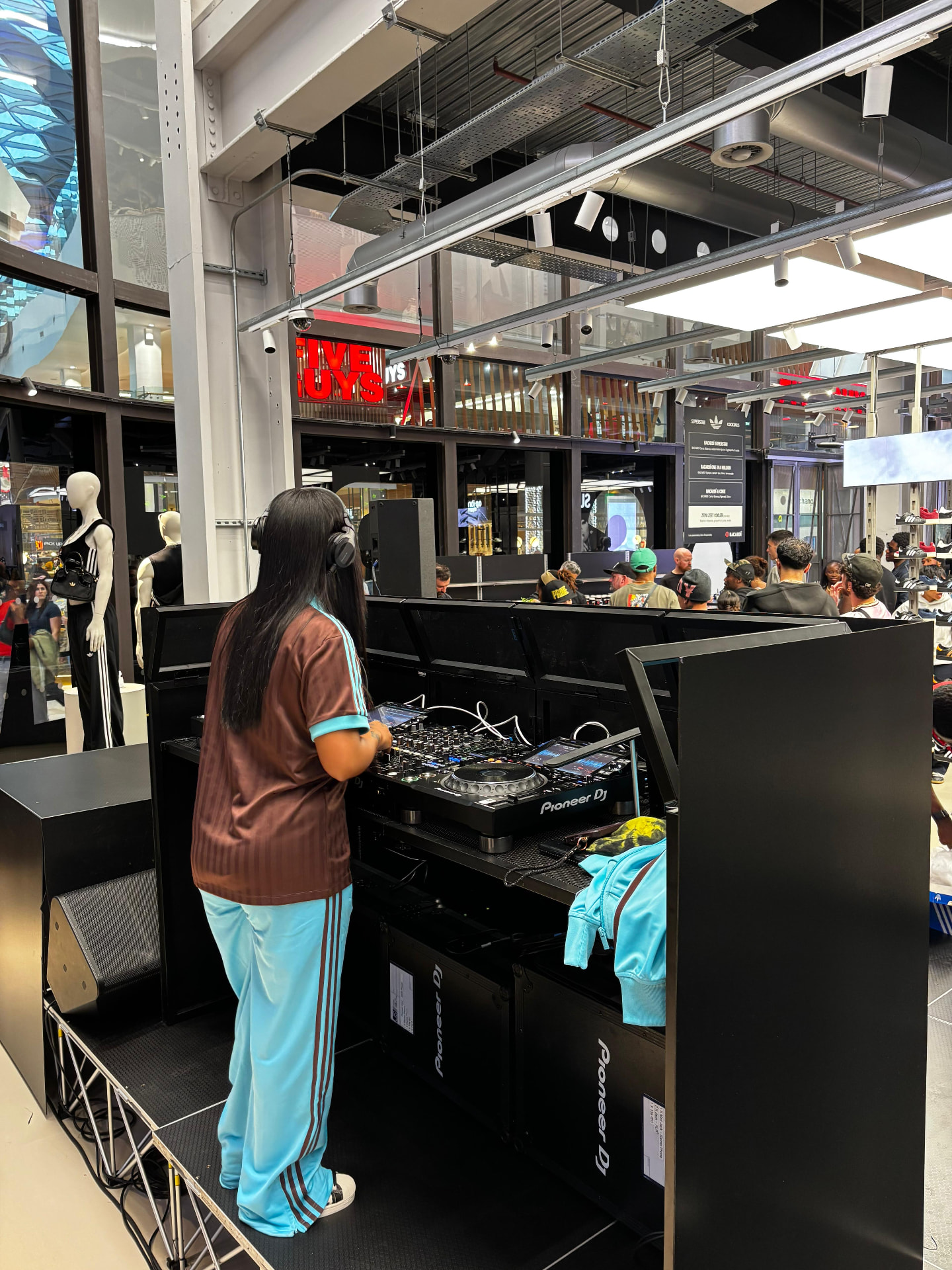 DJ performing on Pioneer CDJ setup at a retail activation