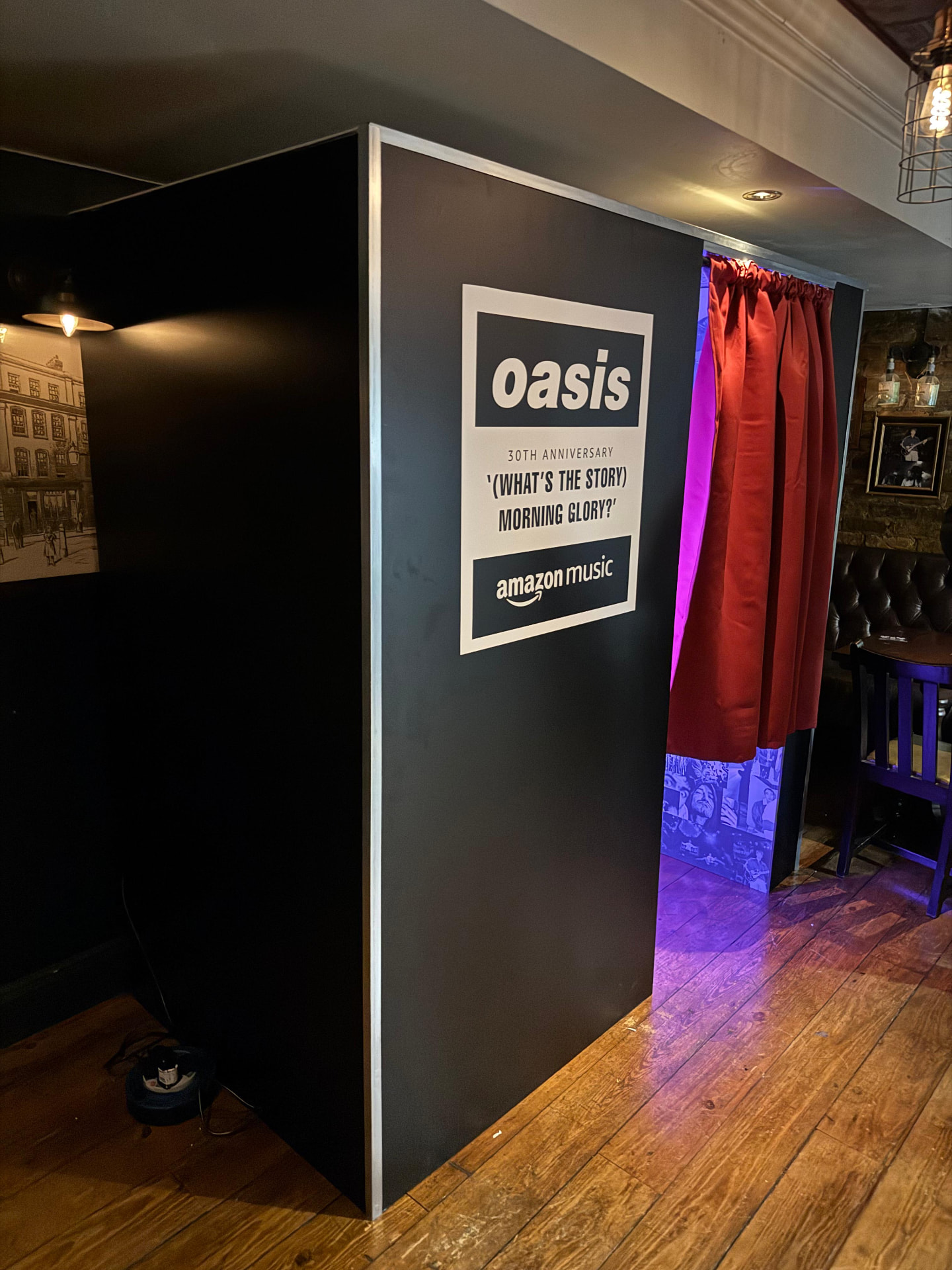 Custom branded photo booth cabin with curtain at a music event
