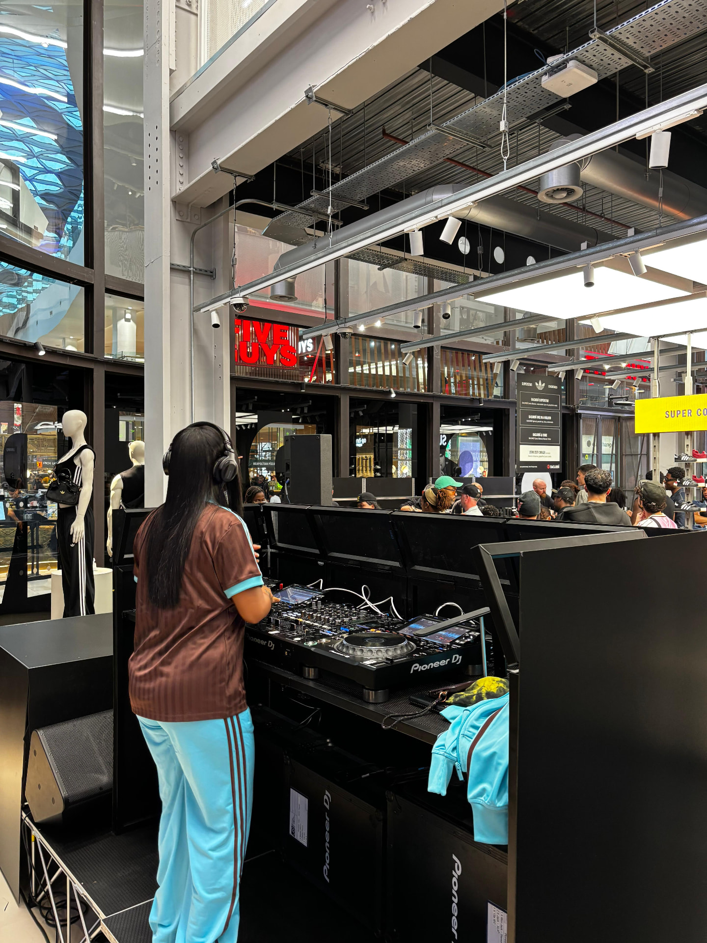 Pioneer DJ booth and monitor speakers on a raised stage platform
