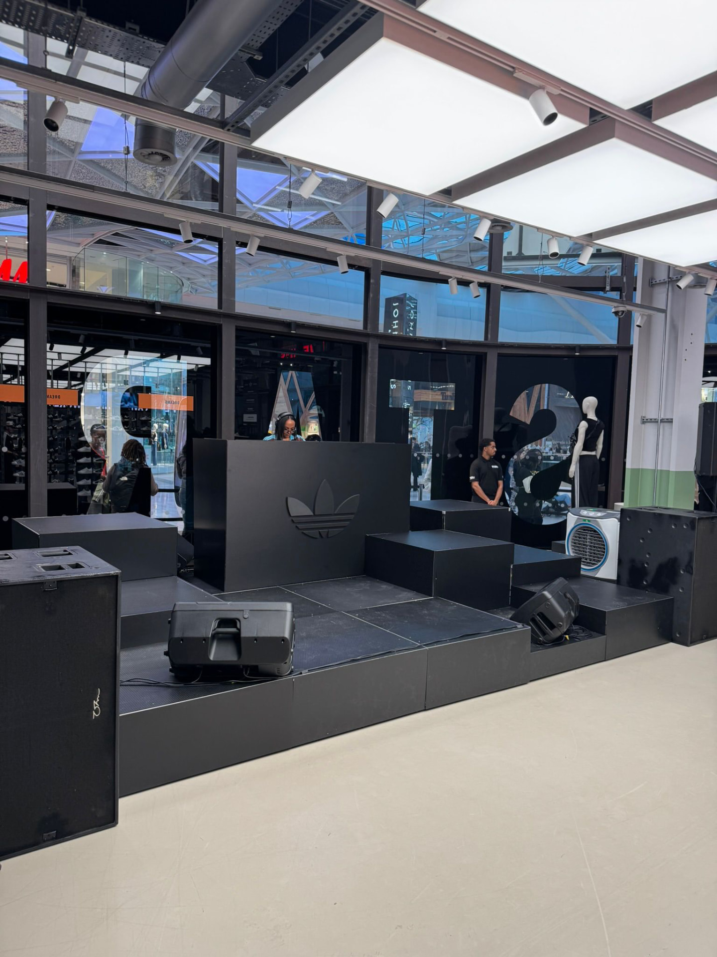 Modular black stage with DJ booth, speakers and cooling fans